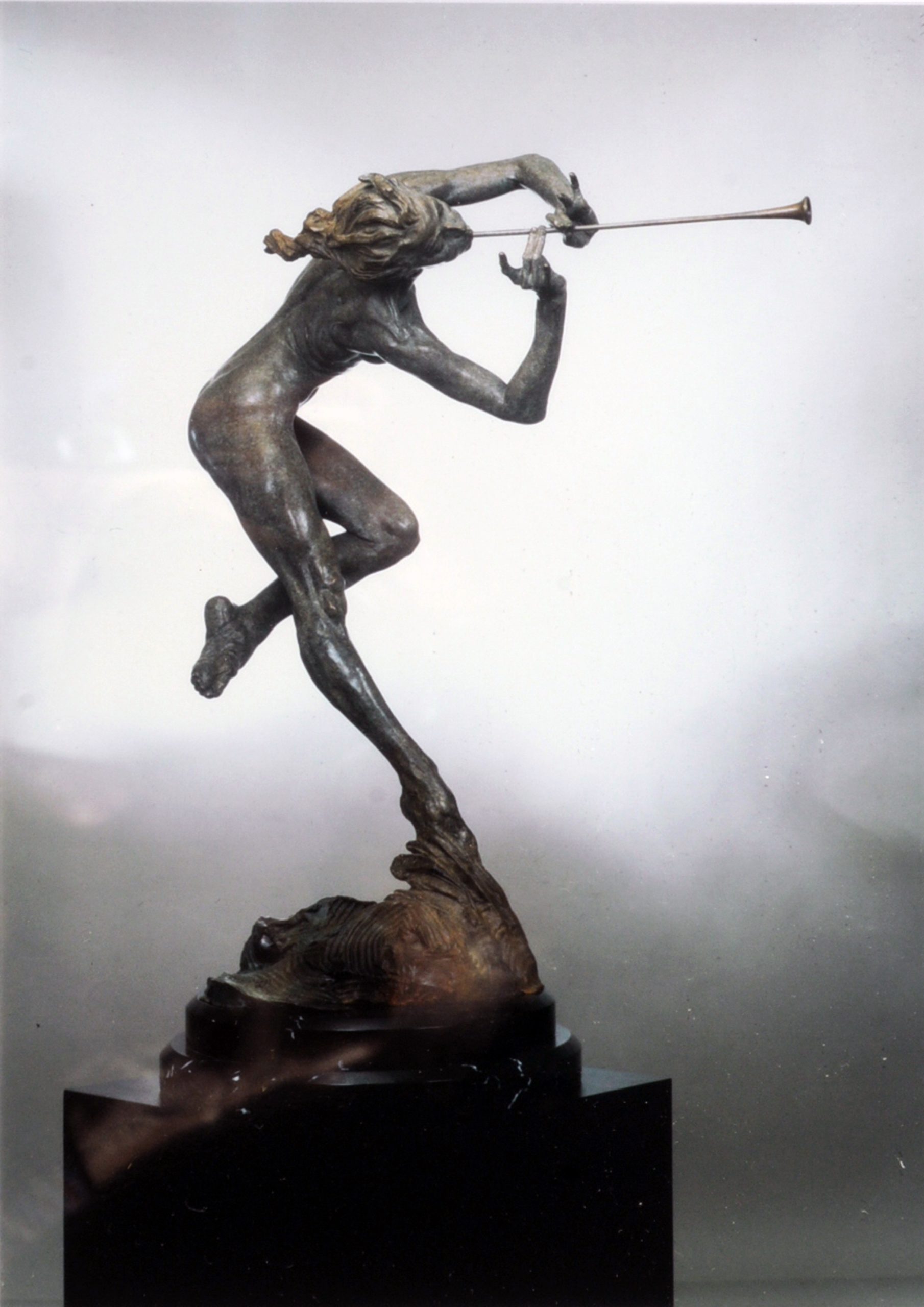cast bronze with a custom hot-applied patina, anchored onto a solid black marble base.